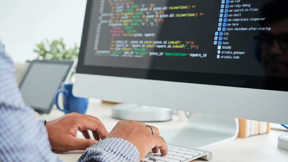 Programmer writing open source digital asset management software